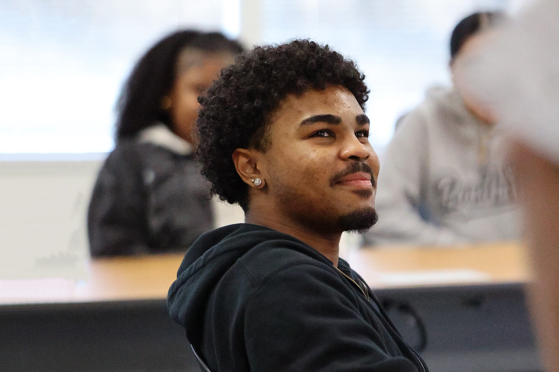 Student smiling during a mentorship conversation