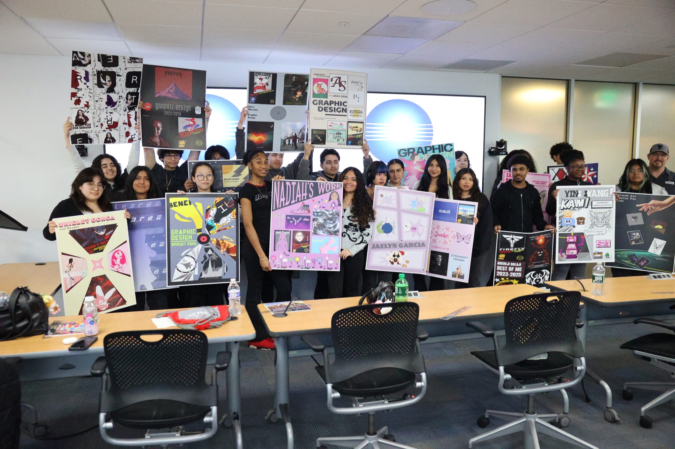 Save 653 students holding finished graphic design projects