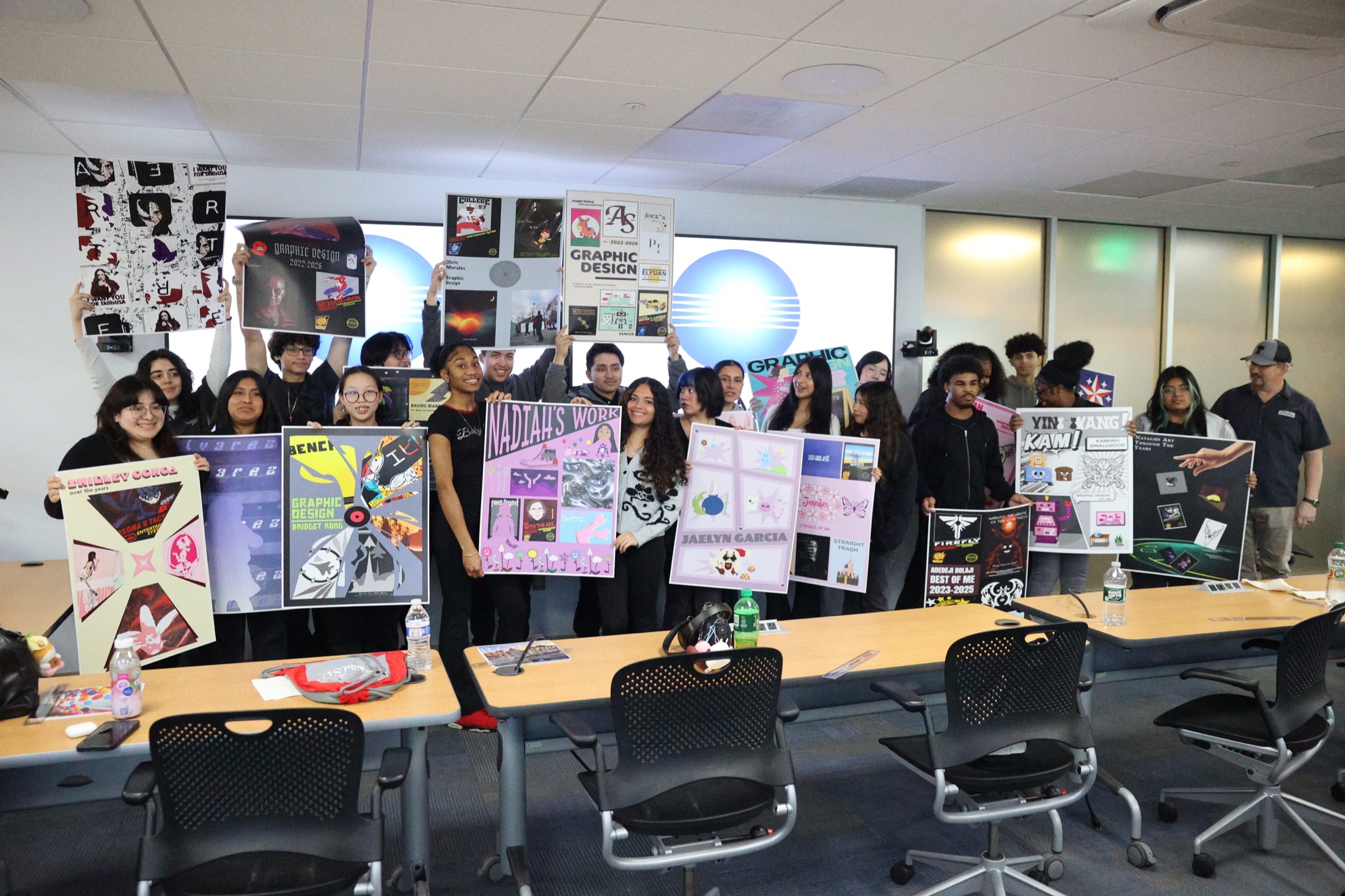 Students presenting graphic design portfolio boards